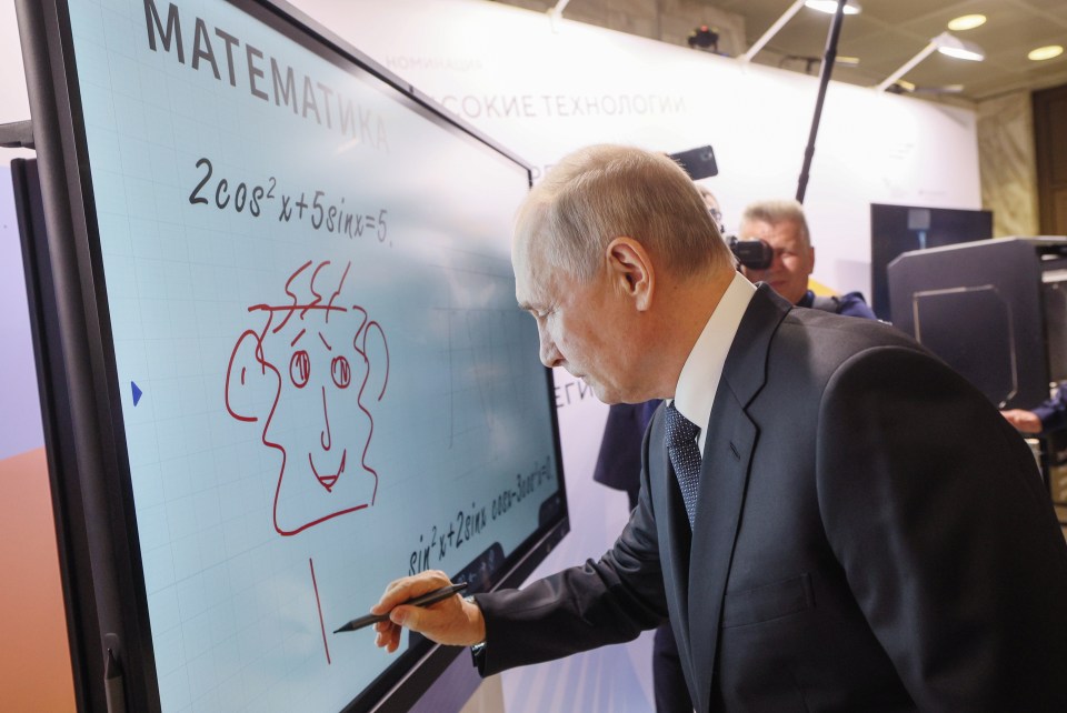 He was snapped drawing a bizarre character on a whiteboard which an expert has now deciphered
