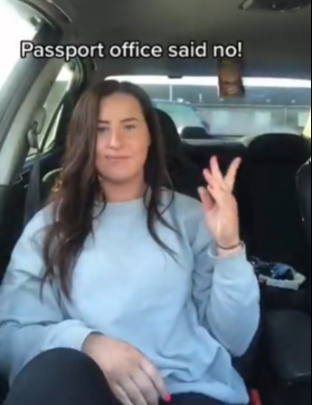 She flings her now useless passport onto the backseat
