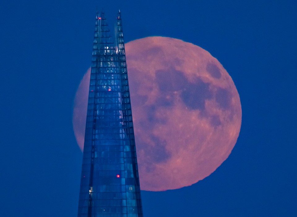 Supermoon rising behind the Shard in London.
