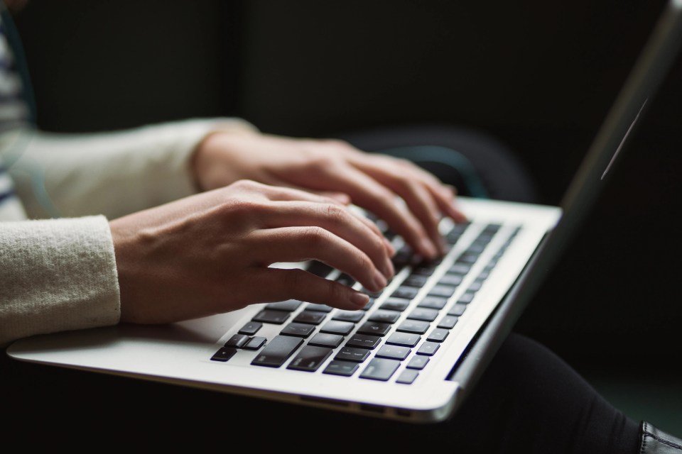 Person typing on a laptop.