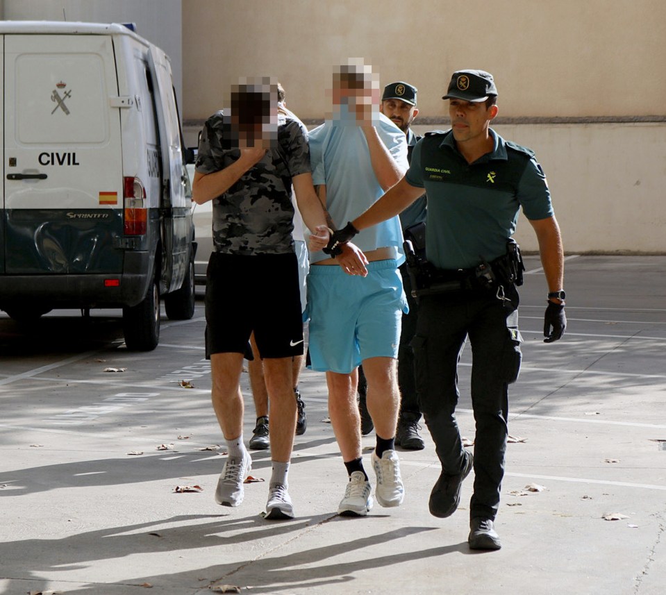 The men covered their faces as they were led to court