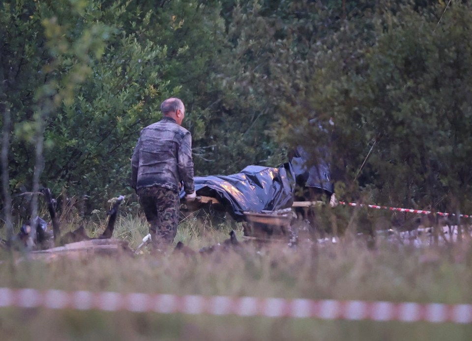 Specialists surveying the burnt-out wreckage