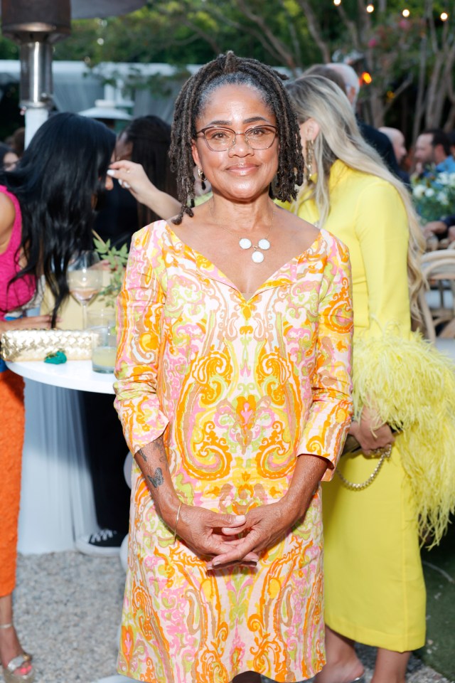 The mum-of-one, 66, looked elegant in an orange and yellow paisley dress