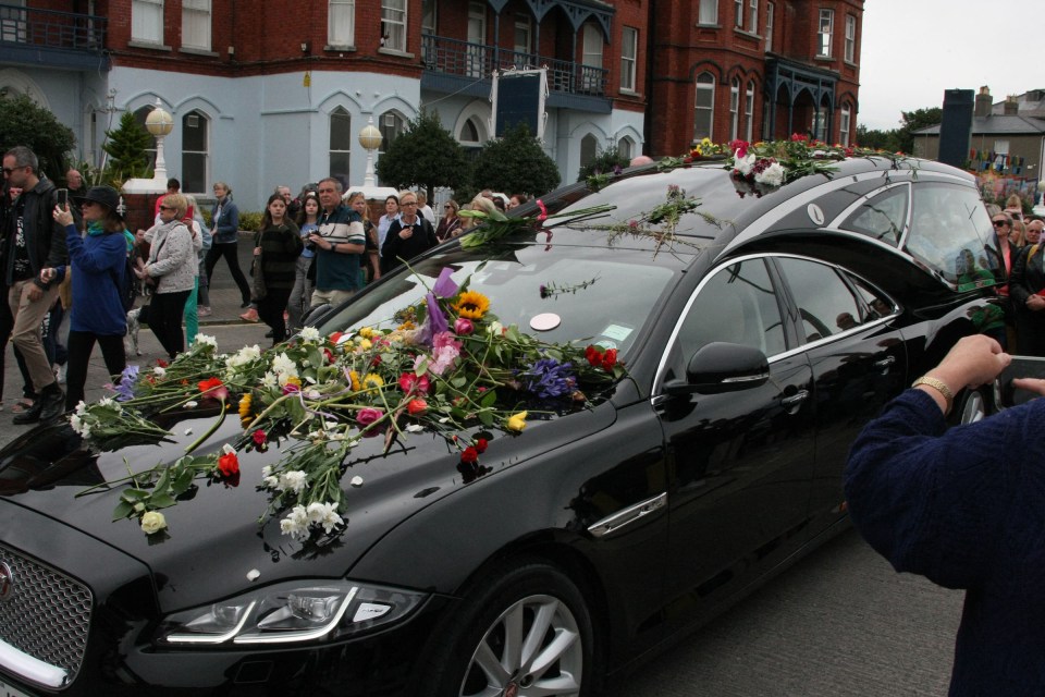 Fans threw flowers on her hearse