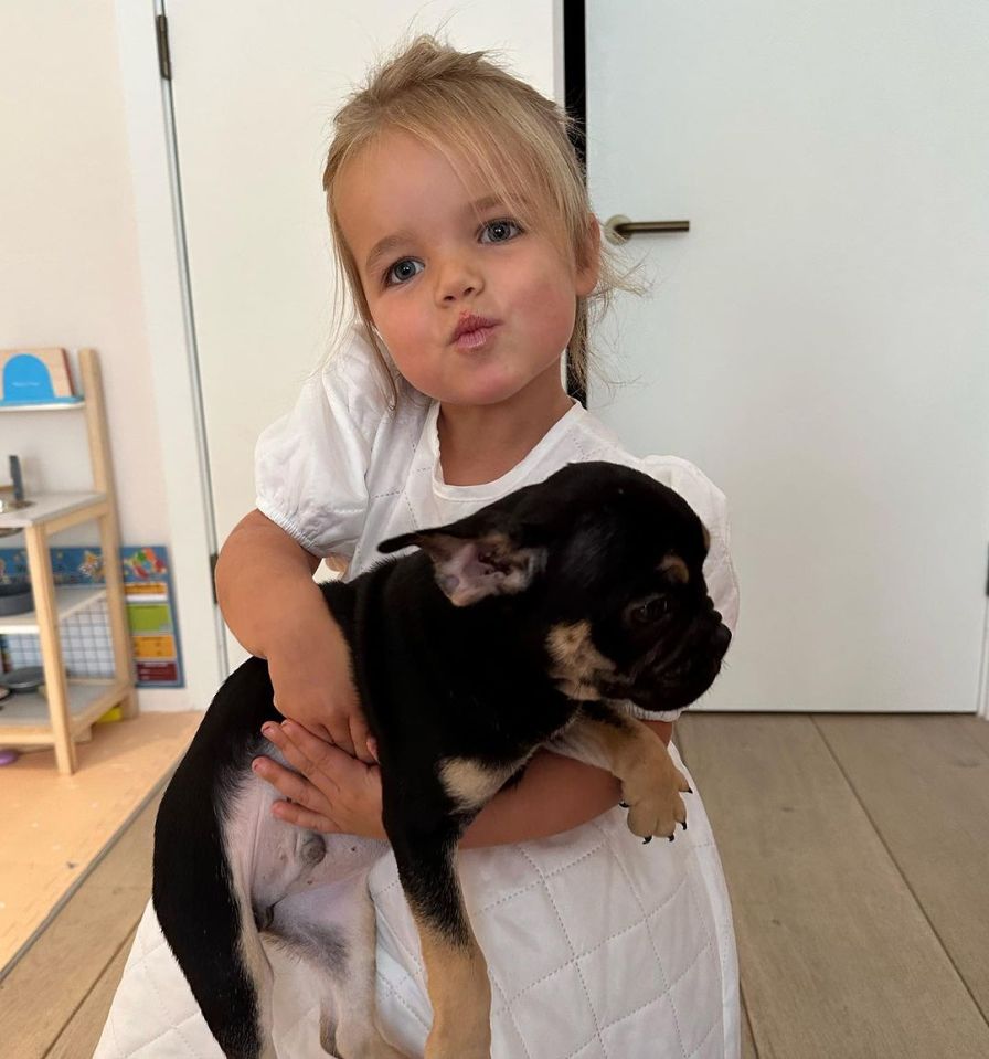 Three-year-old Gigi embraced the pup in snaps shared to Instagram