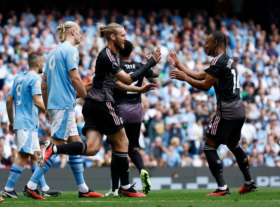 Soccer Football - Premier League - Manchester City v Fulham - Etihad Stadium, Manchester, Britain - September 2, 2023 Fulham's Tim Ream celebrates scoring their first goal with Bobby Decordova-Reid Action Images via Reuters/Jason Cairnduff EDITORIAL USE ONLY. No use with unauthorized audio, video, data, fixture lists, club/league logos or 'live' services. Online in-match use limited to 75 images, no video emulation. No use in betting, games or single club /league/player publications. Please contact your account representative for further details.