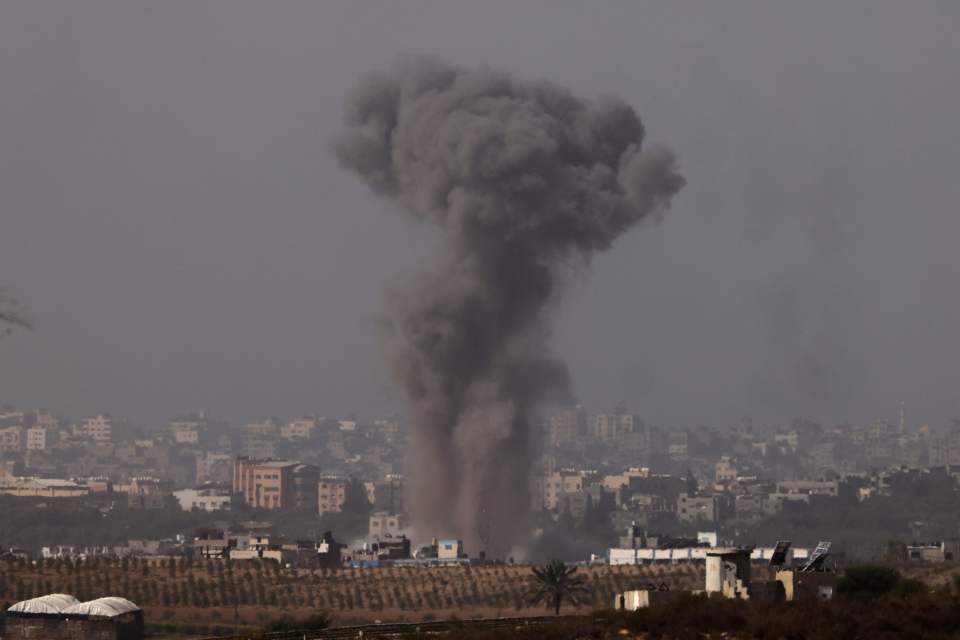 Black smoke billows over the northern Gaza Strip, as seen from Sderot