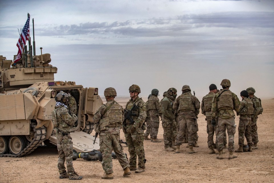 US soldiers attend a joint military exercise between the Syrian Democratic Forces (SDF) and the US-led international coalition against the Islamic State (IS) group, in the countryside of Deir Ezzor in northeastern Syria on December 7, 2021. (Photo by Delil souleiman / AFP) (Photo by DELIL SOULEIMAN/AFP via Getty Images)