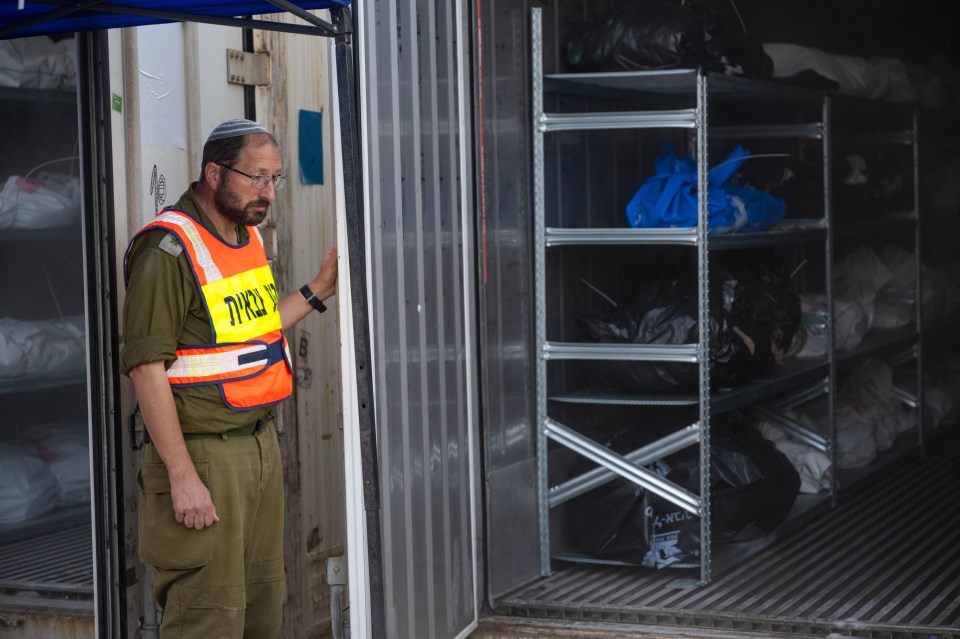 RAMLE, ISRAEL - OCTOBER 24: (Editors note: Image depicts death) Soldiers of the Military Rabbinate unit open a container filled with bodies killed during at the Hamas attack on the Israeli southern border as the process of identifying deceased individuals continues in the Shura army base on October 24, 2023 in Ramle, Israel. As Israel seems poised to invade the Gaza Strip in its campaign to vanquish Hamas, the Palestinian militant group that launched a deadly attack in southern Israel on October 7th, worries are growing of a wider war with multiple fronts, including at the country's northern border with Lebanon. Countries have scrambled to evacuate their citizens from Israel, and Israel has begun relocating residents some communities on its northern border. Meanwhile, hundreds of thousands of residents of northern Gaza have fled to the southern part of the territory, following Israel's vow to launch a ground invasion. (Photo by Alexi J. Rosenfeld/Getty Images)