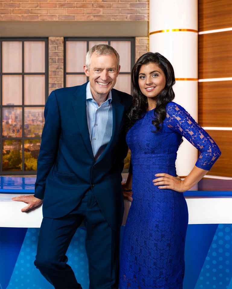 a man in a suit and a woman in a blue dress pose for a picture