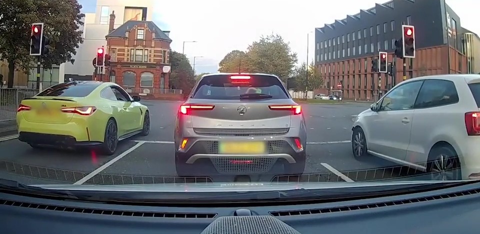 This BMW (left) strayed over white lines at a Birmingham intersection