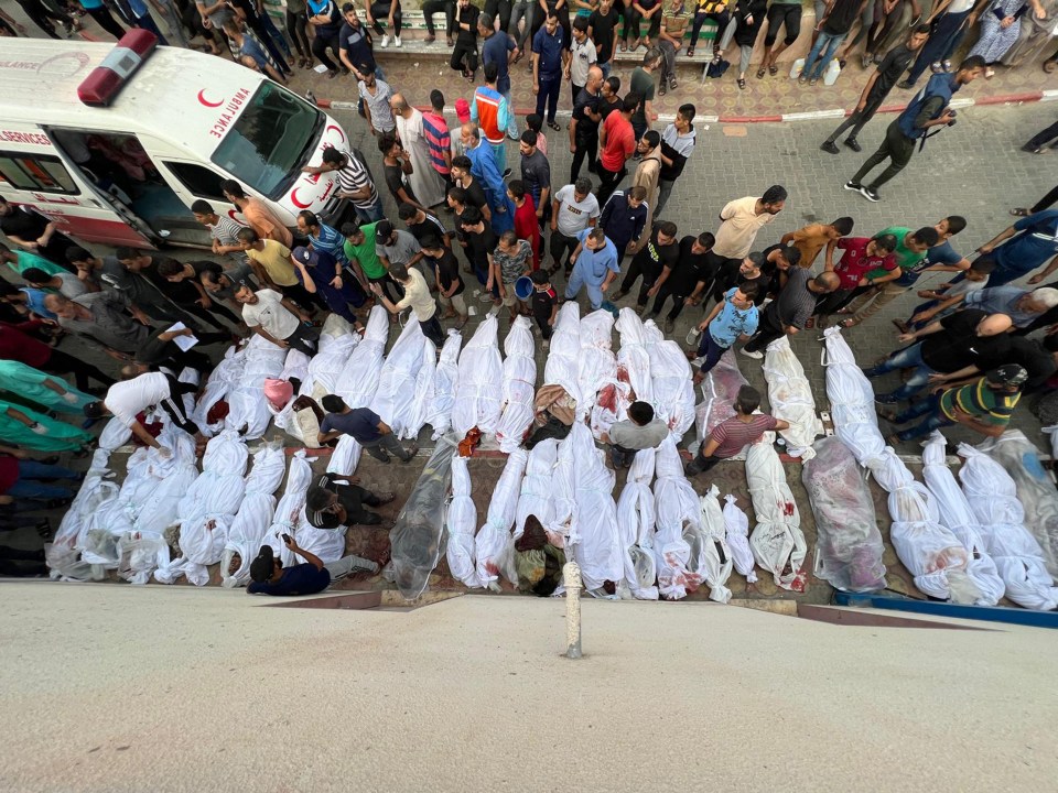 White body bags lined the street following the destruction