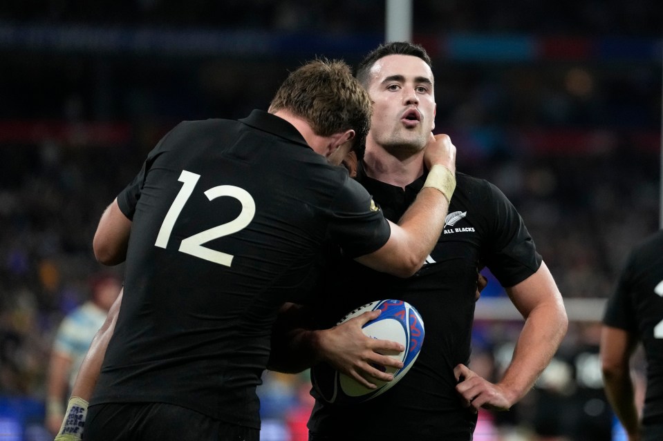 Will Jordan is congratulated on his hat-trick of tries by fellow scorer Barrett as New Zealand beat Argentina 44-6