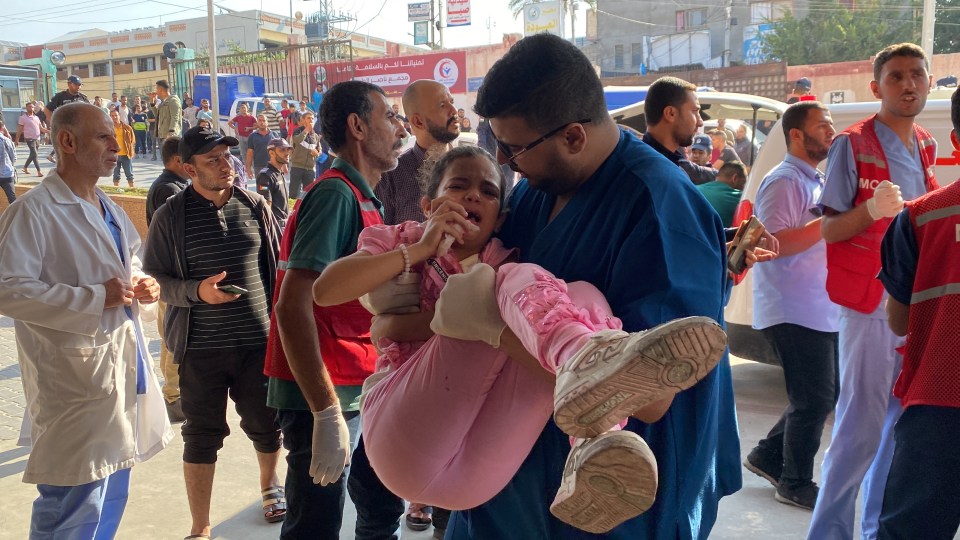 A Palestinian child wounded in Israeli strikes is brought to a hospital