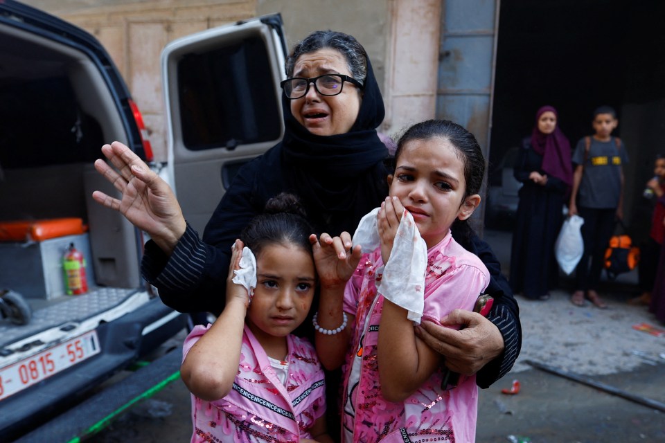 A family cries after being wounded during Israel's bombardment of Gaza