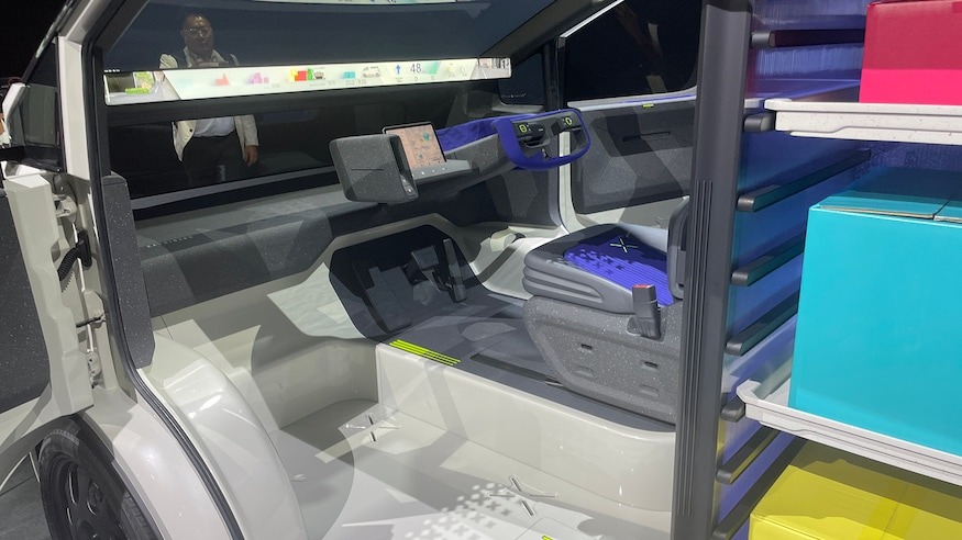 The futuristic cockpit is dominated by a display screen the width of the windshield
