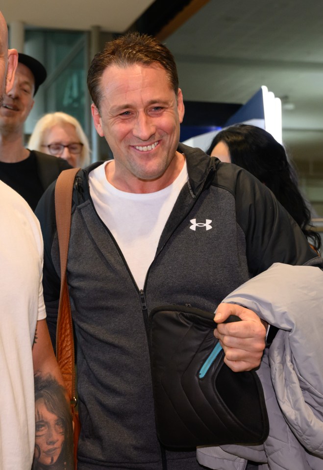 The Hollyoaks legend smiles as he walked through the arrivals lounge