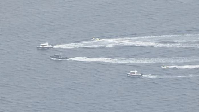 Numerous water and air craft were seen scouring the area after the light aircraft plunged into the bay on Sunday afternoon