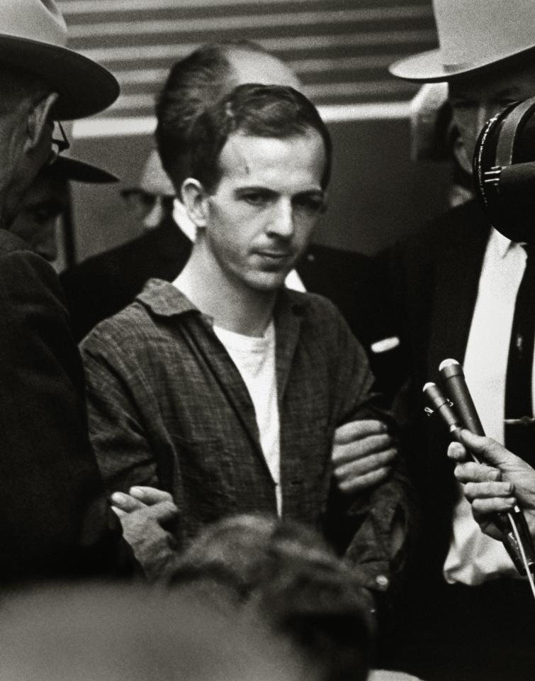 Guards and secret service agents escorting Lee Harvey Oswald through Dallas police HQ two days after his arrest