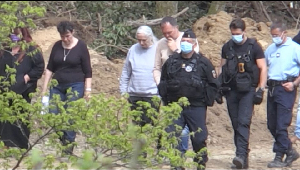 Monique Olivier, in the grey sweatshirt, walks with investigators during the search operation for the remains of nine-year-old Estelle Mouzin in 2021