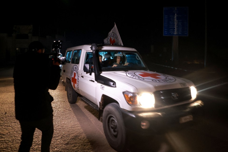 A Red Cross vehicle carrying Israeli hostages arrives at Rafah in the southern Gaza Strip on Thursday night