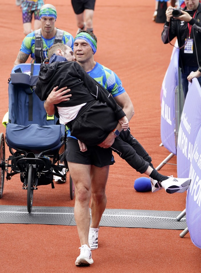 File photo dated 14-05-2023 of Rob Burrow and Kevin Sinfield crossing the finish line. An emotional Kevin Sinfield carried Rob Burrow over the finish line at the inaugural Rob Burrow Leeds Marathon after pushing his great friend and former Rhinos team-mate for 26.2 miles. Issue date: Thursday November 14, 2023. PA Photo. See PA story SPORT Christmas May. Photo credit should read Danny Lawson/PA Wire.