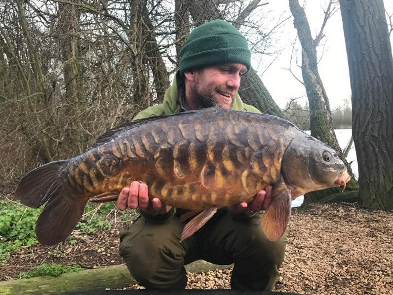 Man holding a large carp.