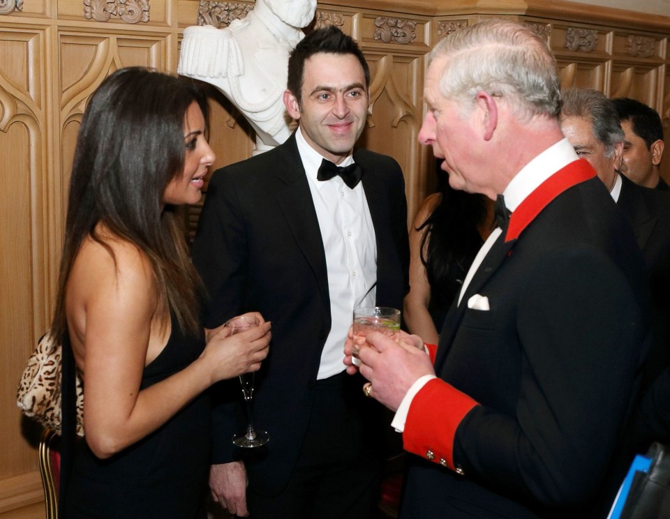 a man in a tuxedo is talking to two women