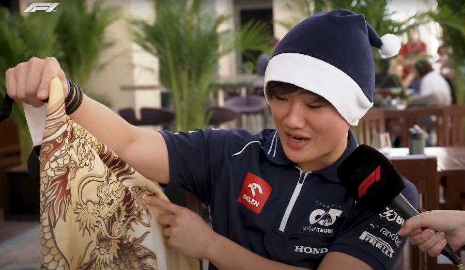 Yuki Tsunoda checks out his Chinese apron