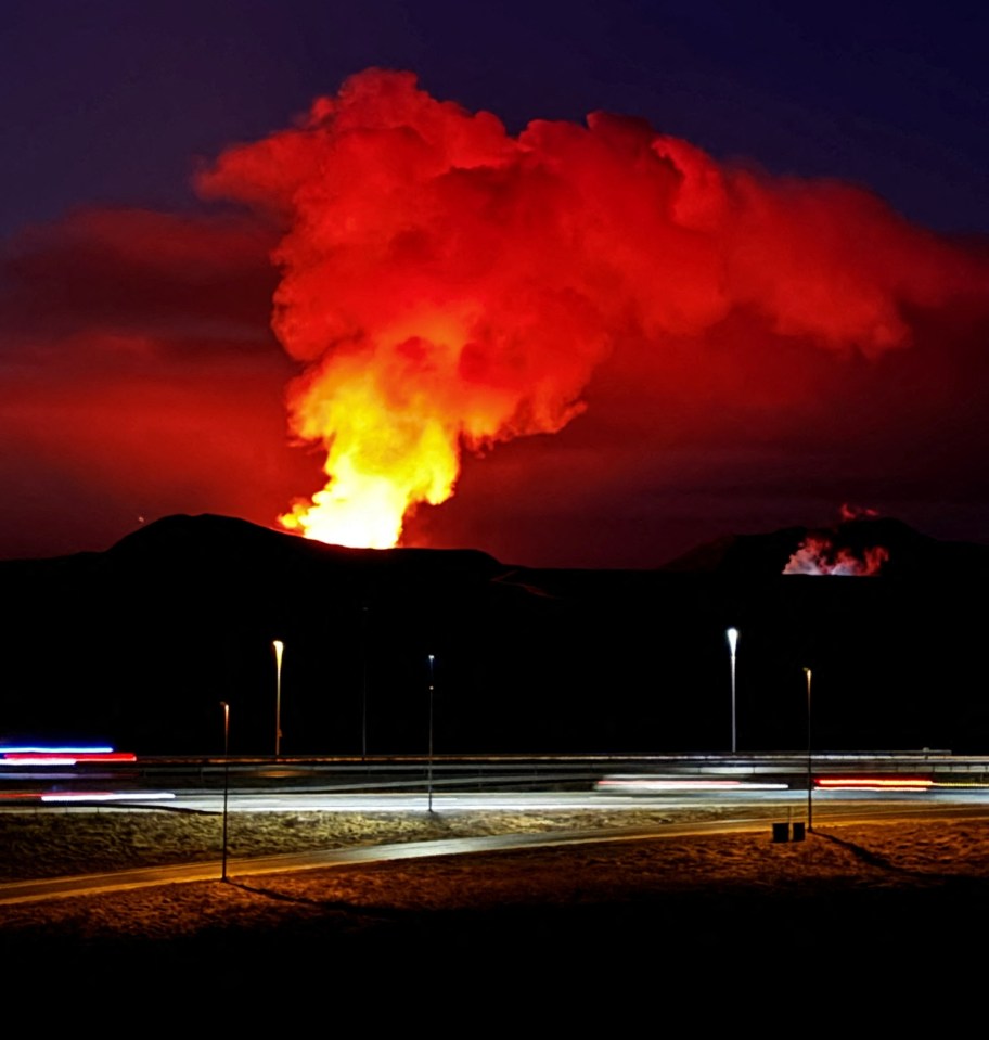 a volcano is erupting at night with a lot of smoke coming out of it