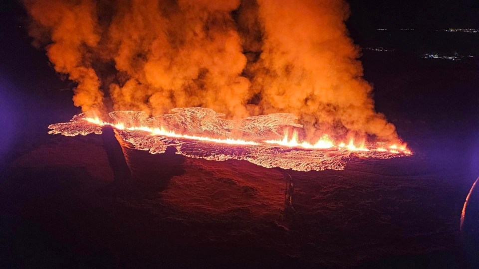 an aerial view of a large fire at night