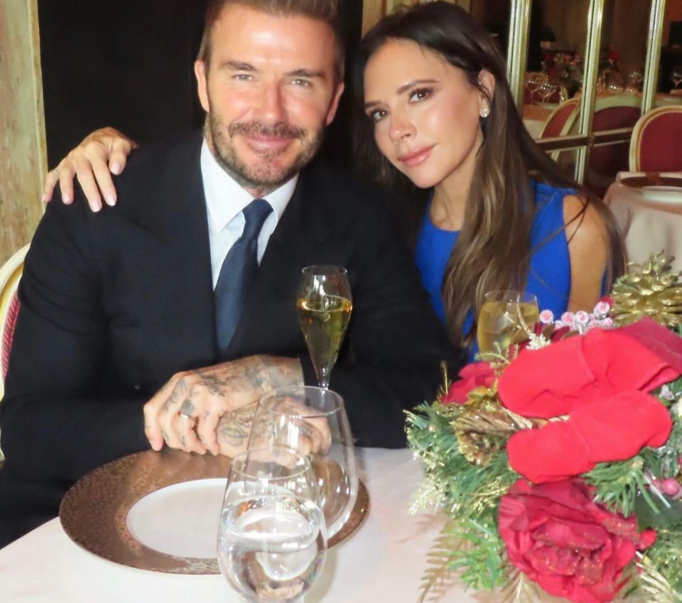 a man and woman sit at a table with glasses of wine