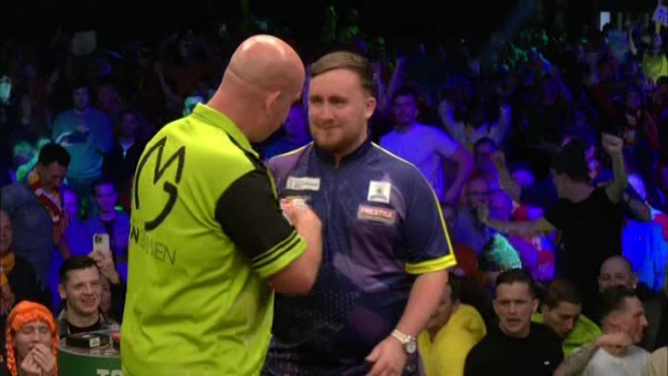 Michael van Gerwen and Luke Littler shake hands after the match