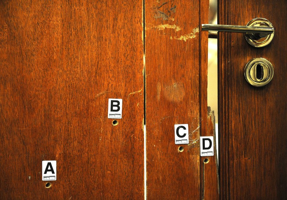 The athlete's bathroom door marked with bullet holes