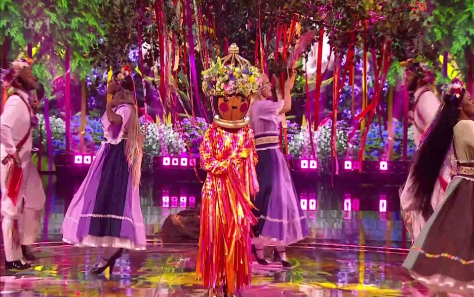 The character donned an extravagant outfit with a floral headpiece