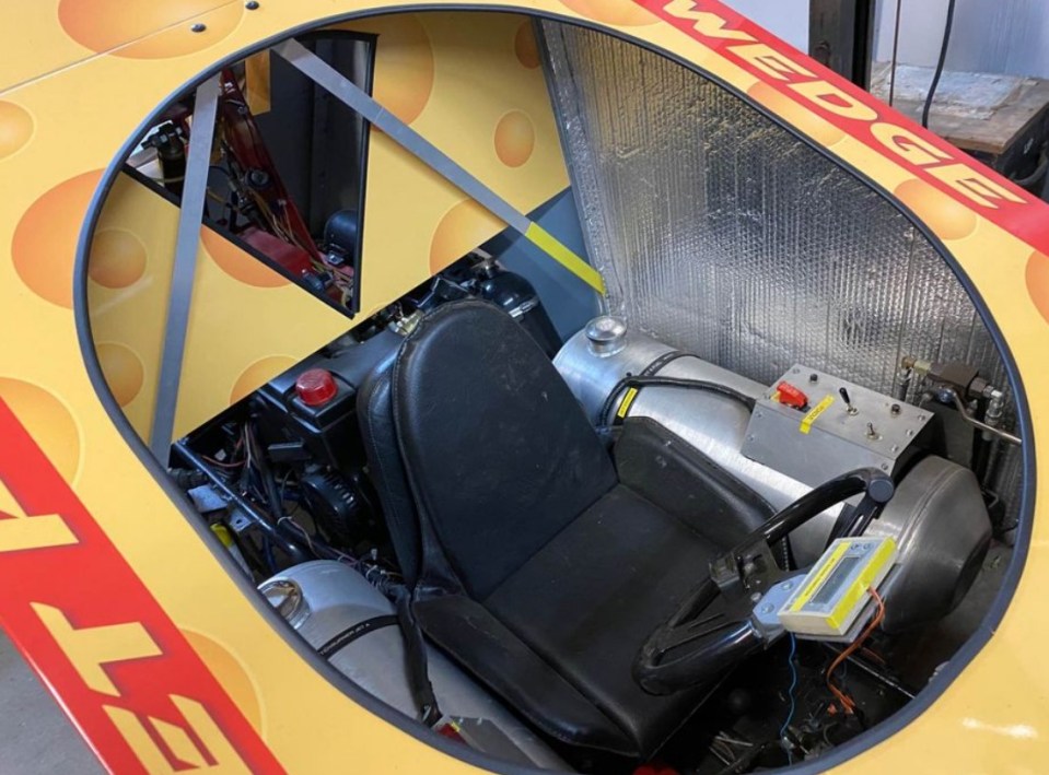 The fuel tanks sit next to the driver's seat while the jet engine is behind a thin board
