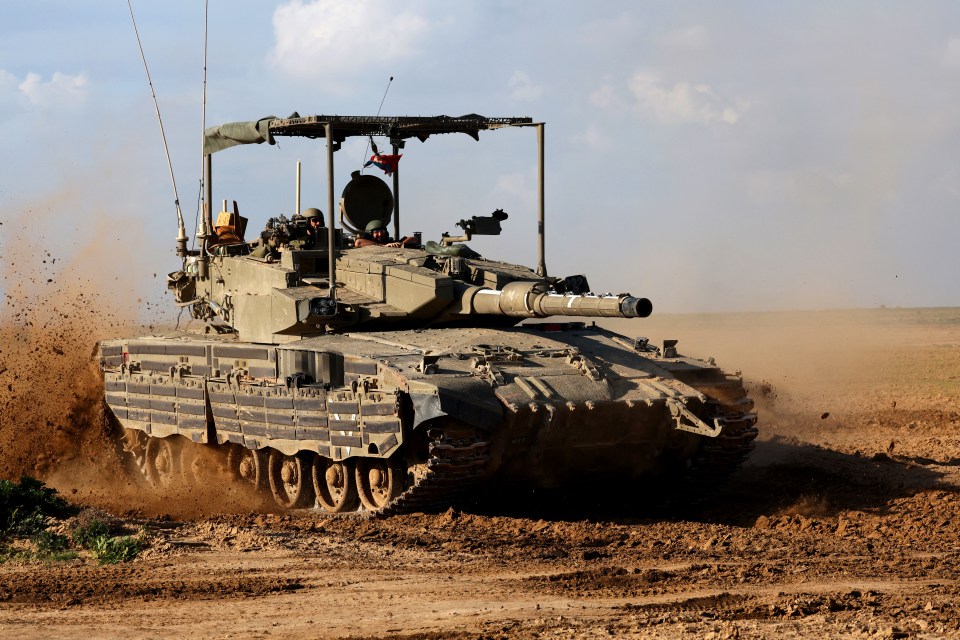 An Israeli army tank rolling alongside the border with the Gaza Strip during the Israel-Hamas war