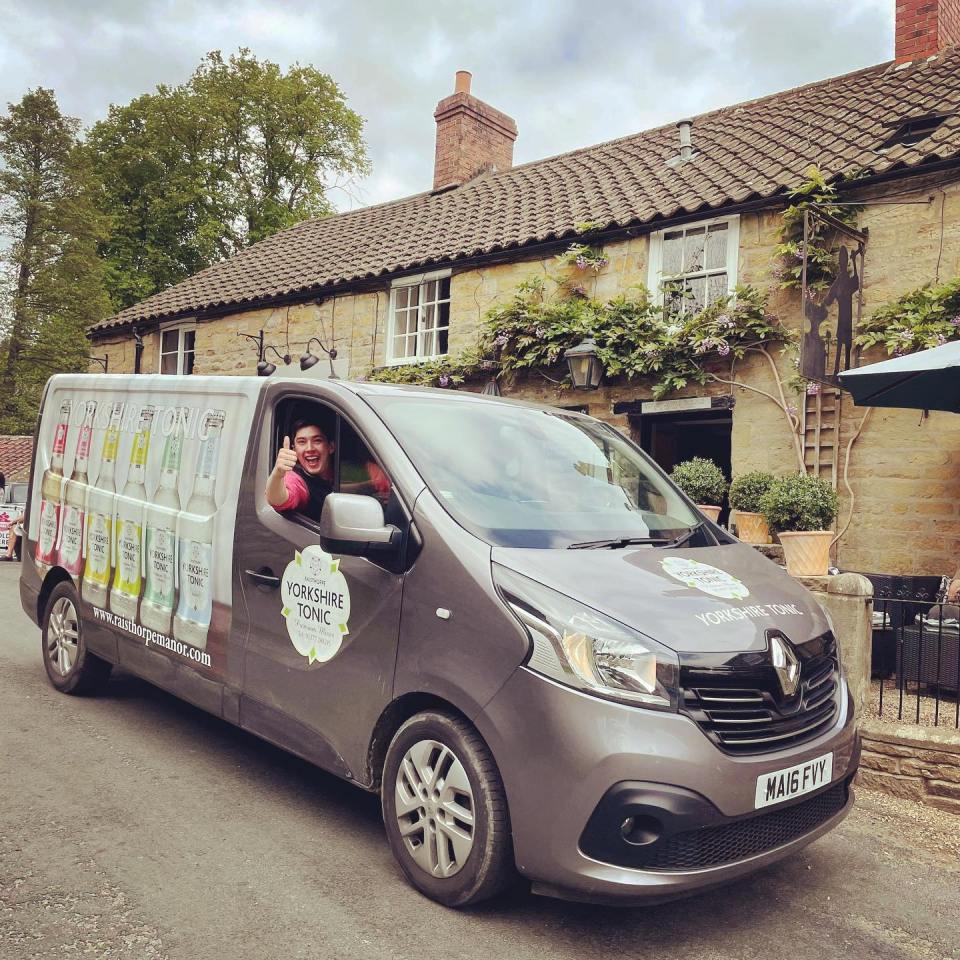 Oliver behind the wheel of his company's Renault van - complete with company logo and stickers