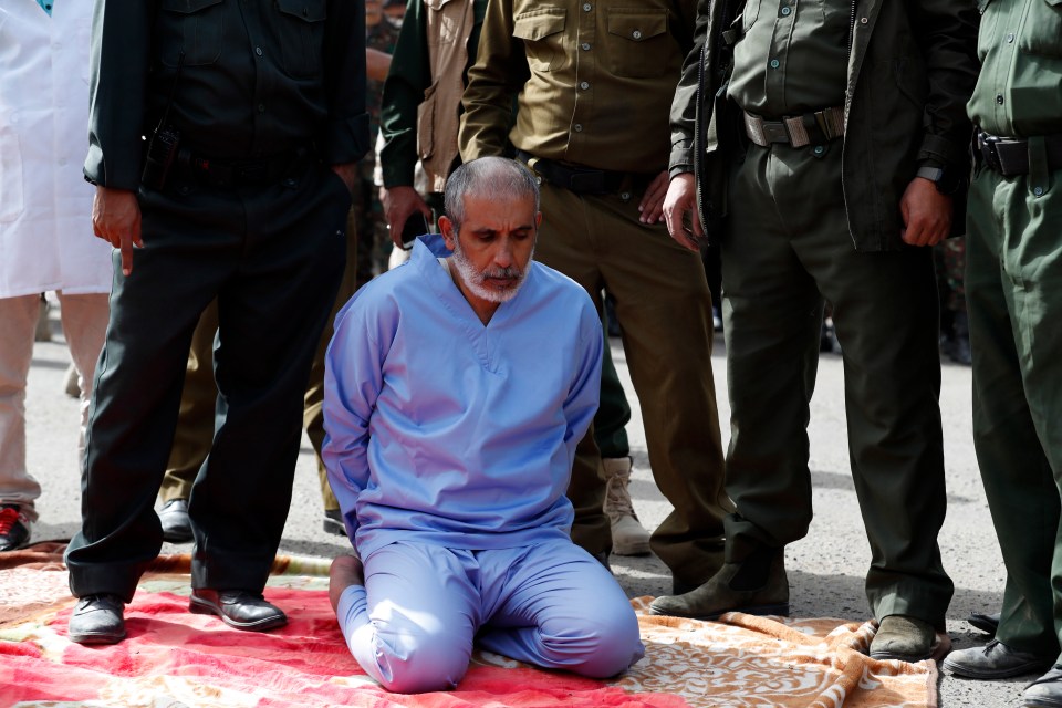 Ali al-Naami, convicted of murdering his three daughters, is placed on a carpet to be executed at a public square in Sanaa