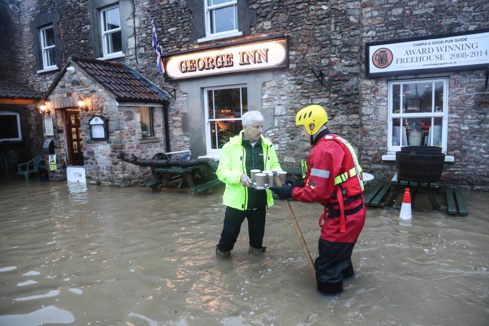 rescue teams moved in to assist stranded residents in Croscombe, Somerset, after the River Sheppey burst its banks
