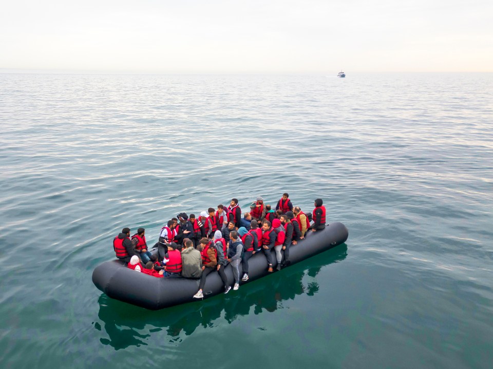 CORRECTED VERSION: THE ENGLISH CHANNEL, ENGLAND - AUGUST 24: In this aerial view, A boat carrying around 50 migrants drifts into English waters as a British Border Control vessel approaches on August 24, 2023 The English Channel, England. Most of the small boats are collected on the border by UK Border Force vessels and brought into Dover port, after french naval ships accompany them to the border. Another boat then collects the small rubber crafts and loads them to be taken to a UK border Force facility. Over 100,000 migrants have crossed the Channel from France to England on small boats since the UK began publicly recording the arrivals in 2018. (Photo by Dan Kitwood/Getty Images)