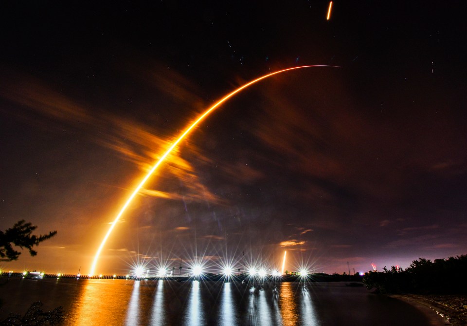 A SpaceX Falcon 9 rocket is launched from a pad at Kennedy Space Center, seen from Port Canaveral, Florida