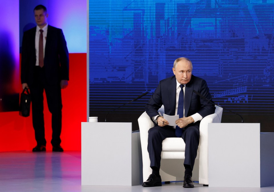 The bodyguard carrying the shield behind Putin