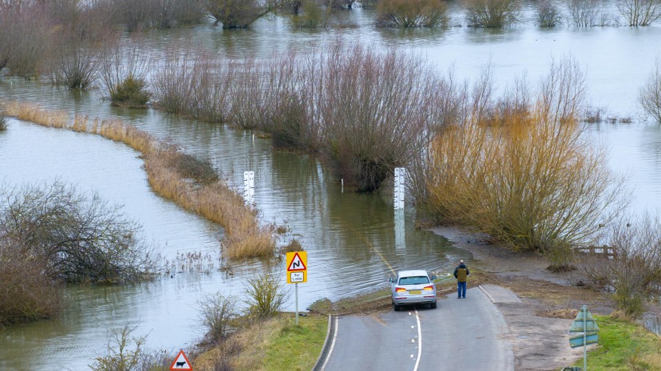 Driver going no further on the A1101, Britain's lowest road, in Welney, Norfolk, on Saturday morning after the New Bedford River burst its banks