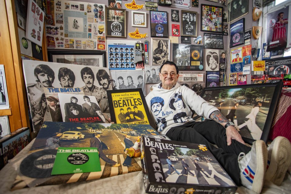 David Presley, now known as John Paul George Ringo Lennon, with a selection of his Beatles memorabilia