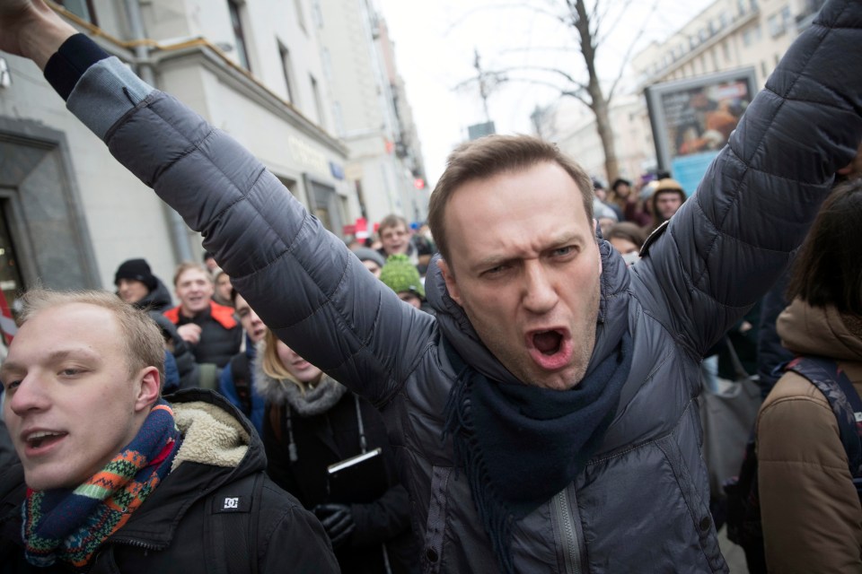 Russian opposition leader Alexei Navalny, centre, shouts slogans as he attends a rally in Moscow, Russia, Sunday, Jan. 28, 2018. Navalny has been arrested in Moscow as protests take place across the country. (AP Photo/Evgeny Feldman)
