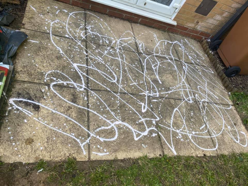 Patio with white paint splatters.