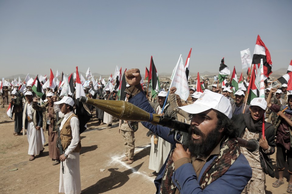 People attend a ceremony organised by the Houthis