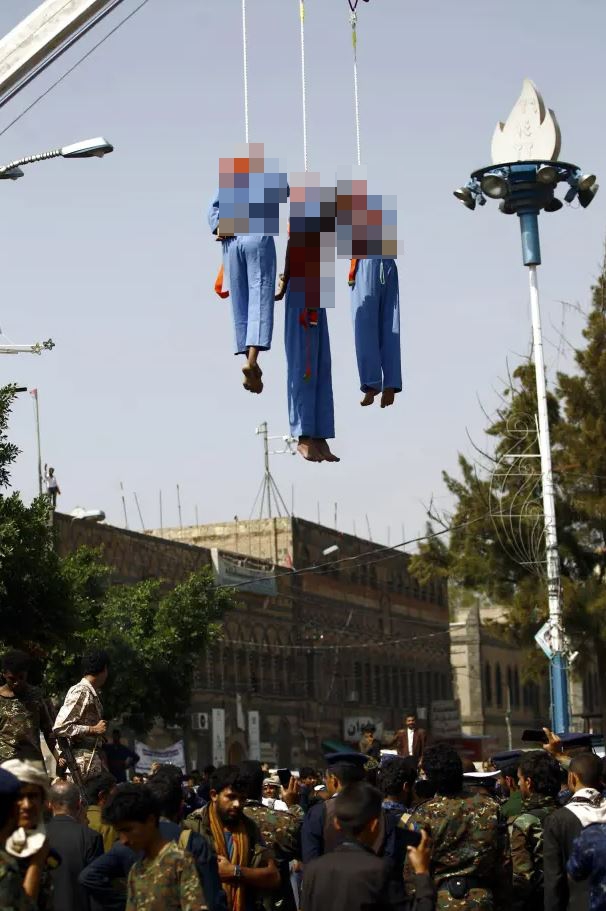 Three men are hung from a crane after being accused of murdering a child