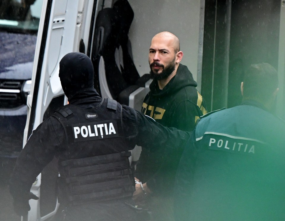 British-US former professional kickboxer and controversial influencer Andrew Tate (R) is led by police officers to the Court of Appeal in Bucharest, Romania on March 12, 2024, following his and his brother's arrest over UK sex offence charges. Romanian authorities said in a statement that they executed "two European arrest warrants issued by the UK judicial authorities for the committing of sexual offences, of exploitation of persons on the territory of the UK". A Bucharest court of appeals is expected to rule later on March 12 whether to extend their detention. (Photo by Daniel MIHAILESCU / AFP) (Photo by DANIEL MIHAILESCU/AFP via Getty Images)